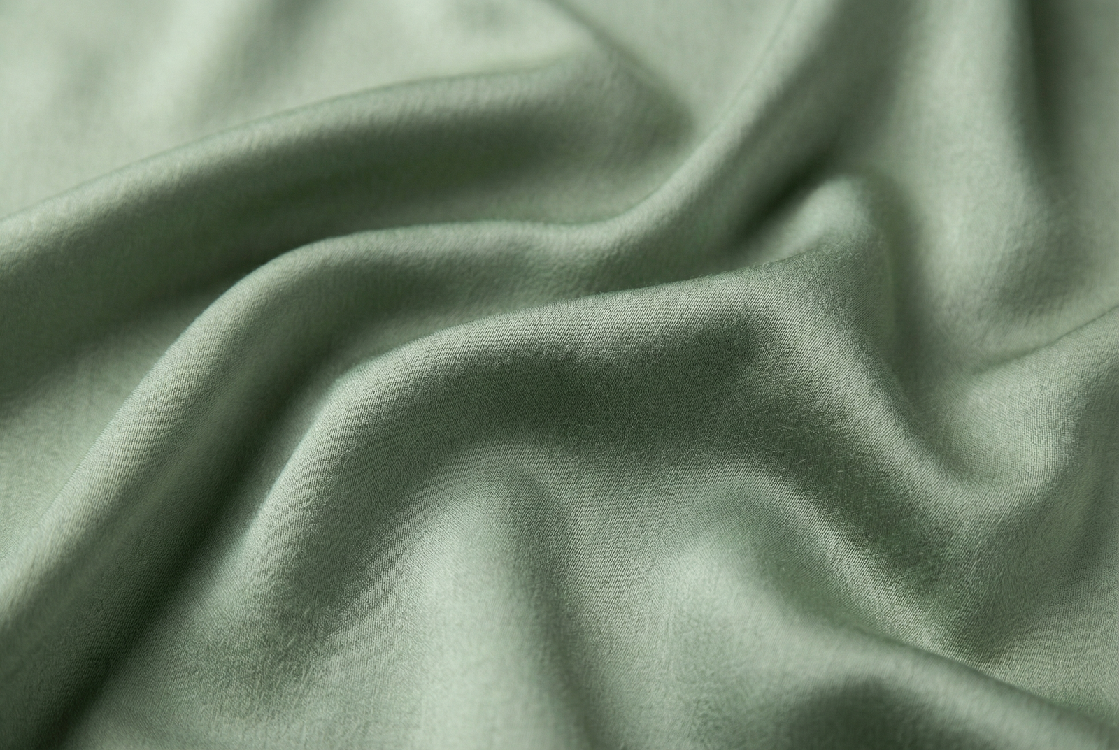 Close up texture of soft bamboo viscose fabric showing silky drape and breathability.