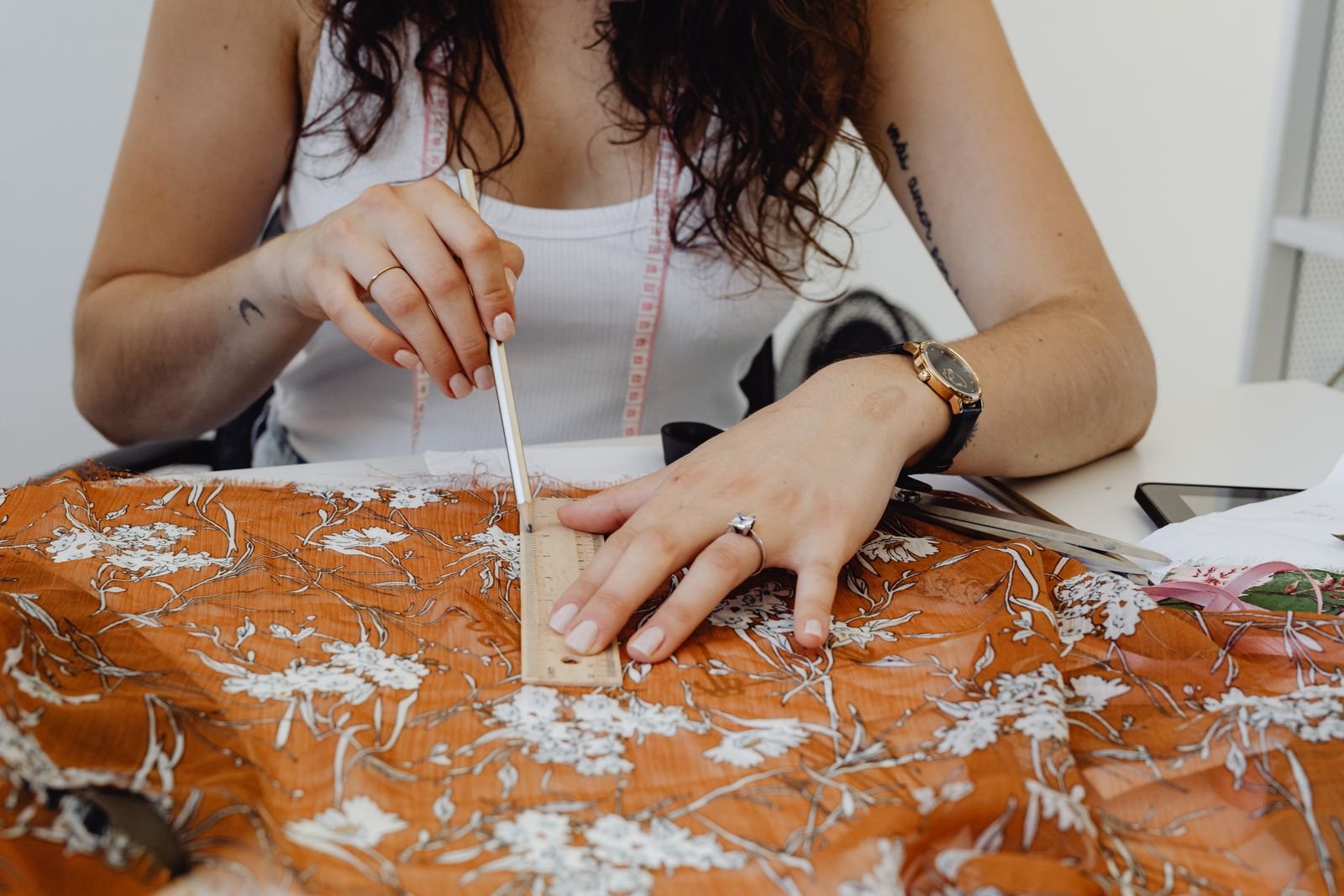 Designer measuring fabric before a garment shrinkage test