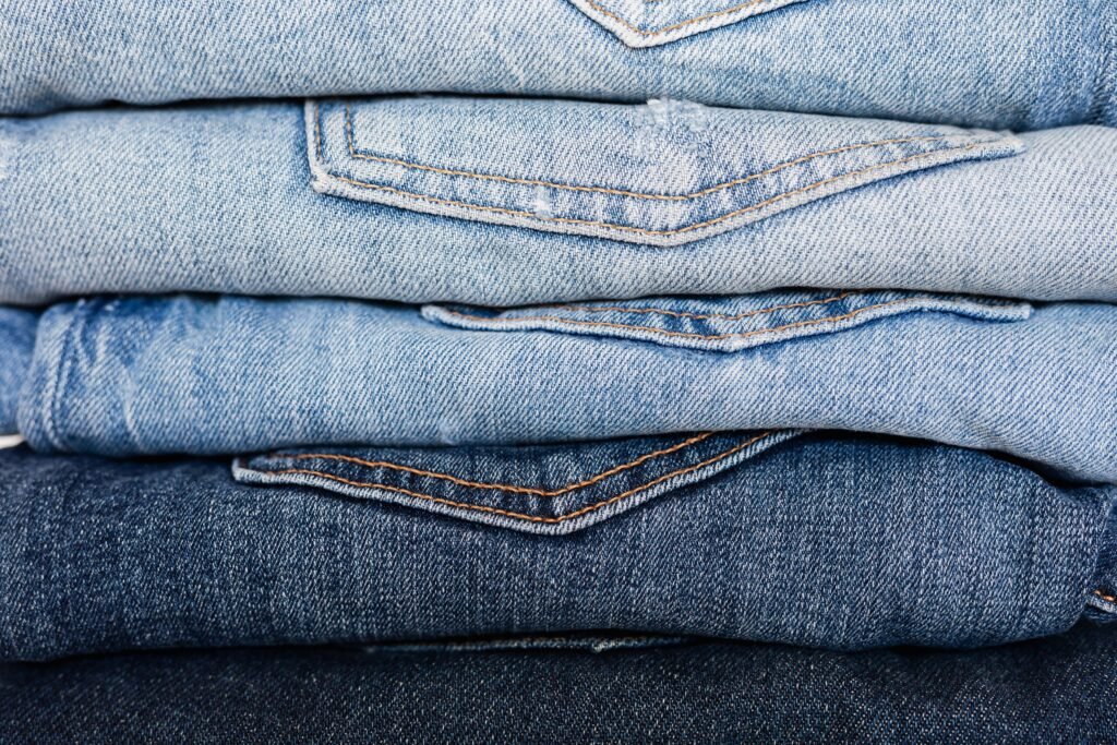 Folded blue denim jeans showing different indigo shades
