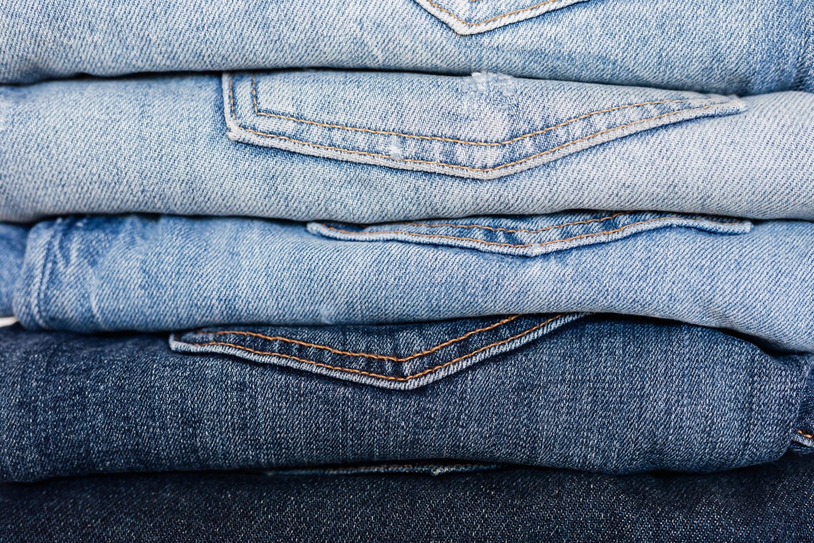 Folded blue denim jeans showing different indigo shades